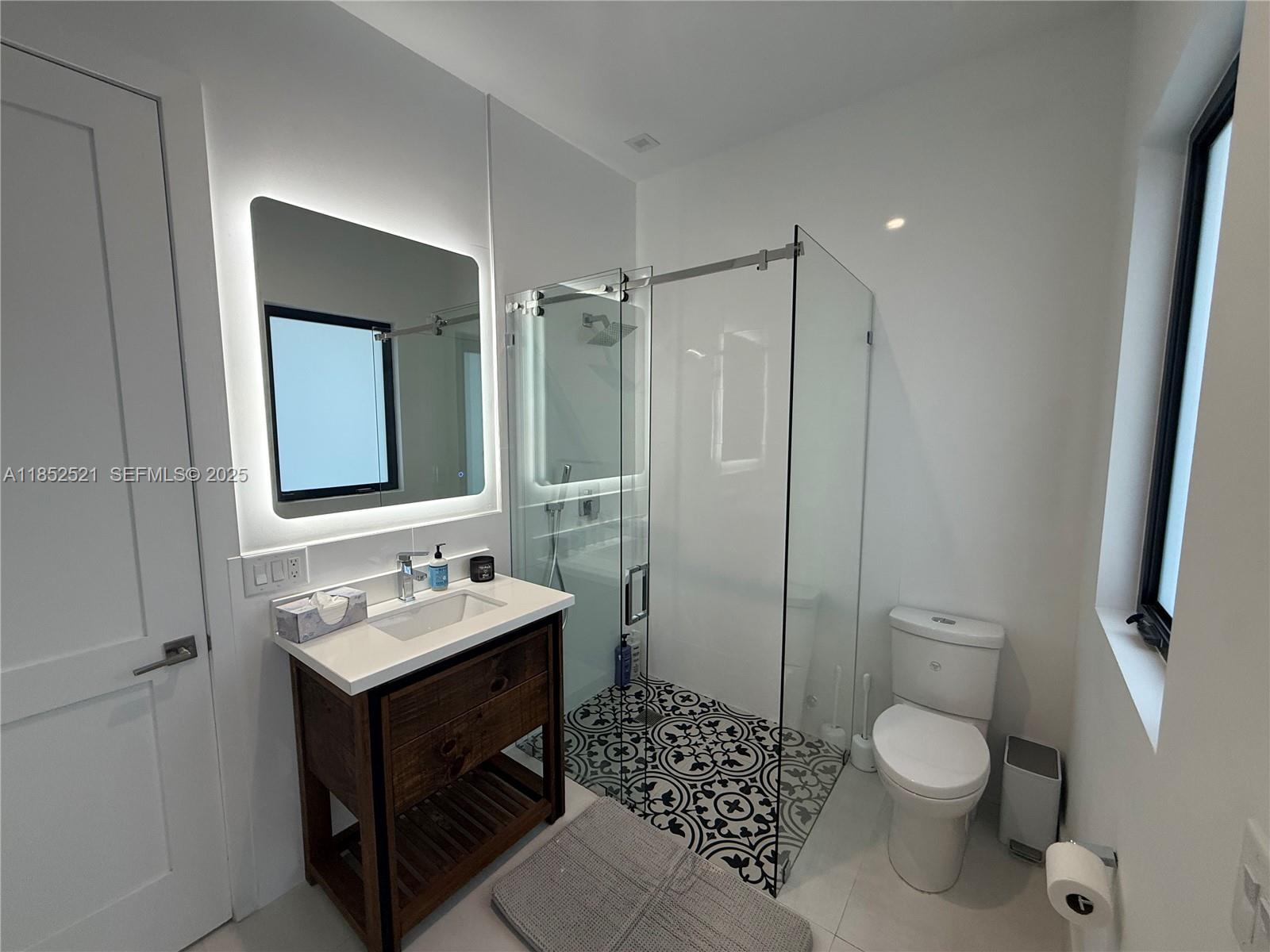 9600 Southwest 66th Street Miami, FL 33173 - Photo 43 of 56 a bathroom with a toilet a sink and mirror