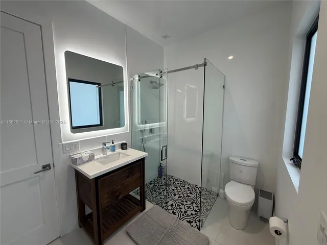 a view of swimming pool with seating space and trees in the background