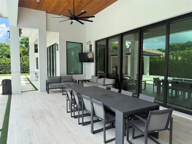 a view of a patio with table and chairs and potted plants