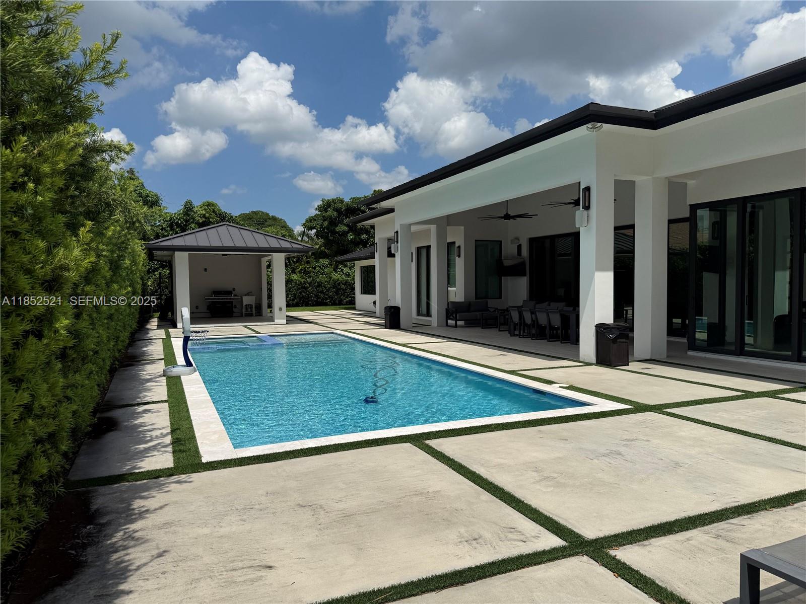 9600 Southwest 66th Street Miami, FL 33173 - Photo 48 of 56 front view of a house with a swimming pool