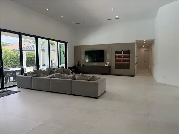 a living room with furniture and large windows