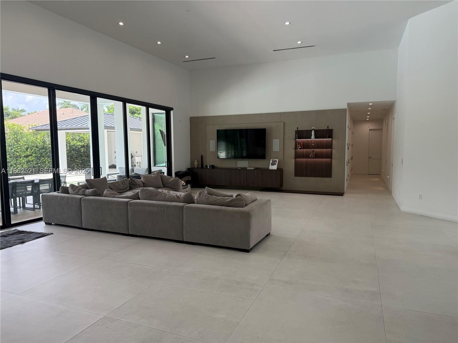 9600 Southwest 66th Street Miami, FL 33173 - Photo 5 of 56 a living room with furniture and a flat screen tv
