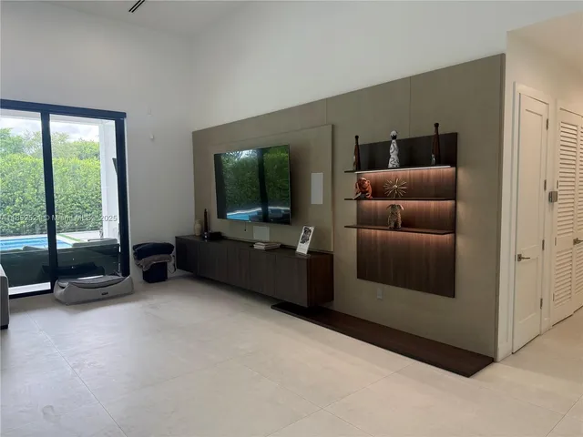 a kitchen with stainless steel appliances a sink a stove a refrigerator and cabinets