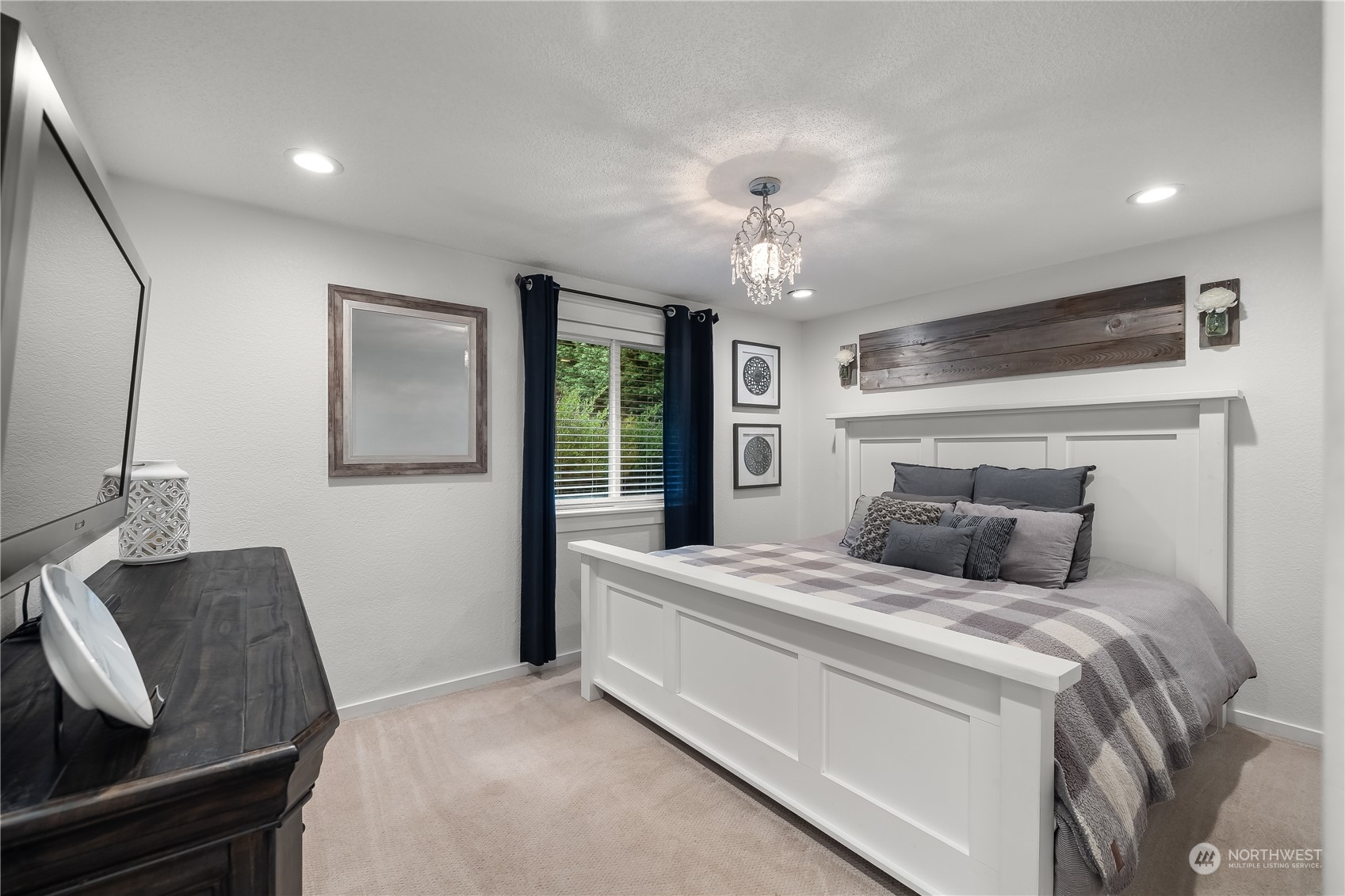 3529 Eagle Drive Northeast Olympia, WA 98516 - Photo 11 of 29 a bedroom with a large bed and a chandelier