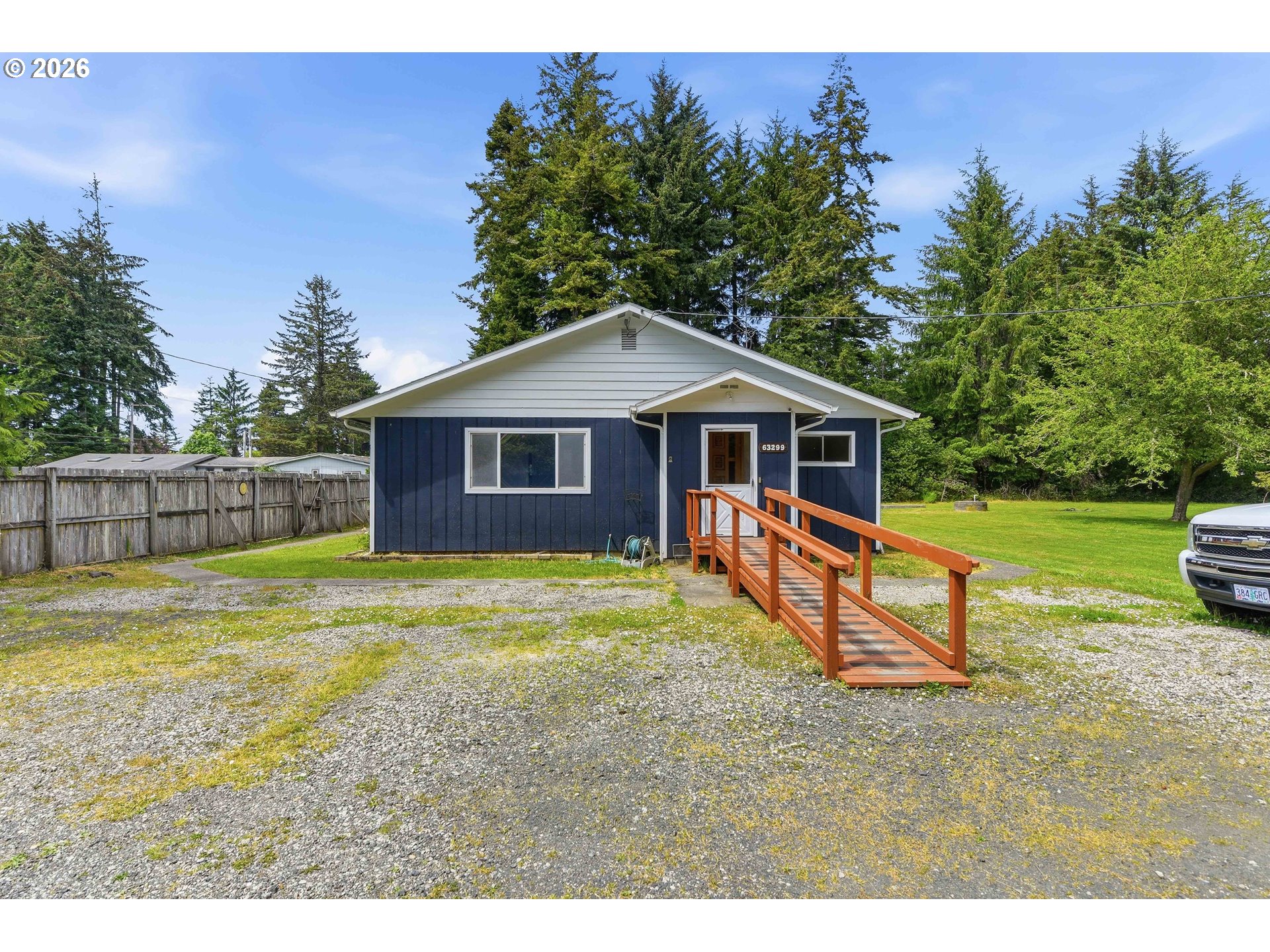 63299 Wildahl Road Coos Bay, OR 97420 - Photo 9 of 45 a view of a house with backyard and a tree