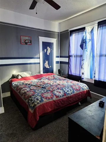 a living room with furniture a window and gym equipment