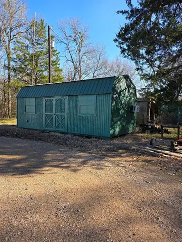 a view of a lush green forest with houses