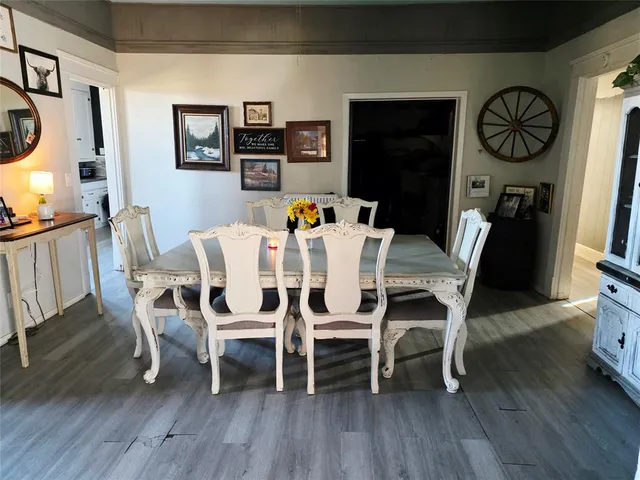 a dining room with furniture a rug and wooden floor