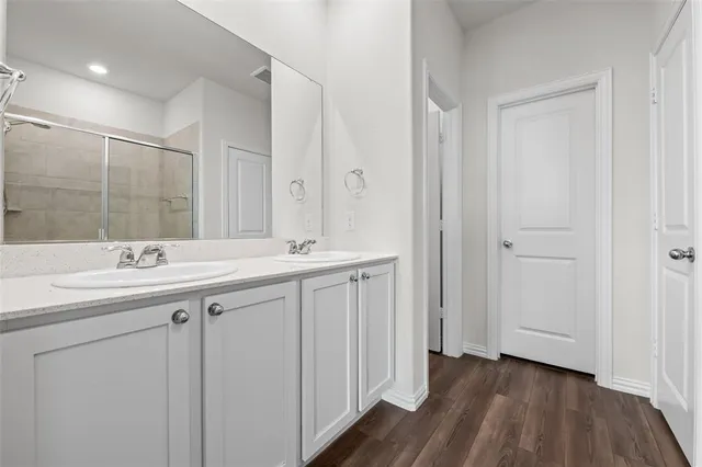 a bathroom with a glass shower door