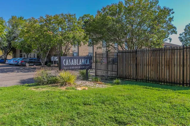a view of garden with wooden fence