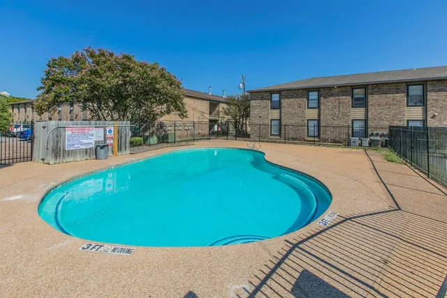 a swimming pool with outdoor seating and yard