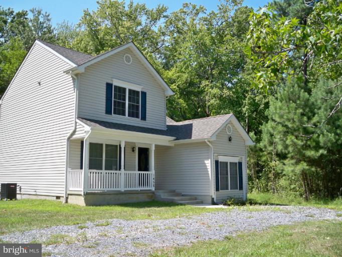 1458 Cox Neck Road Chester, MD 21619 - Photo 2 of 20 a front view of a house with a yard and garage