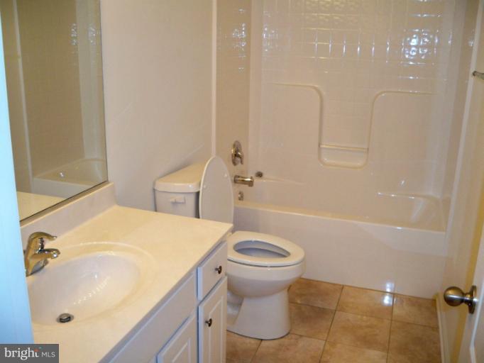 1458 Cox Neck Road Chester, MD 21619 - Photo 17 of 20 a bathroom with a sink a toilet and shower