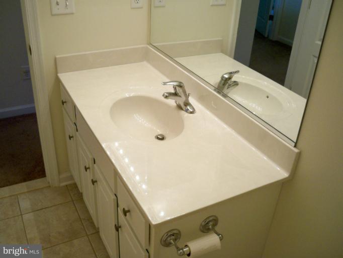 1458 Cox Neck Road Chester, MD 21619 - Photo 18 of 20 a bathroom with a double vanity sink and mirror