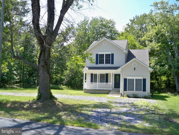 1458 Cox Neck Road Chester, MD 21619 - Photo 3 of 20 a front view of a house with a yard