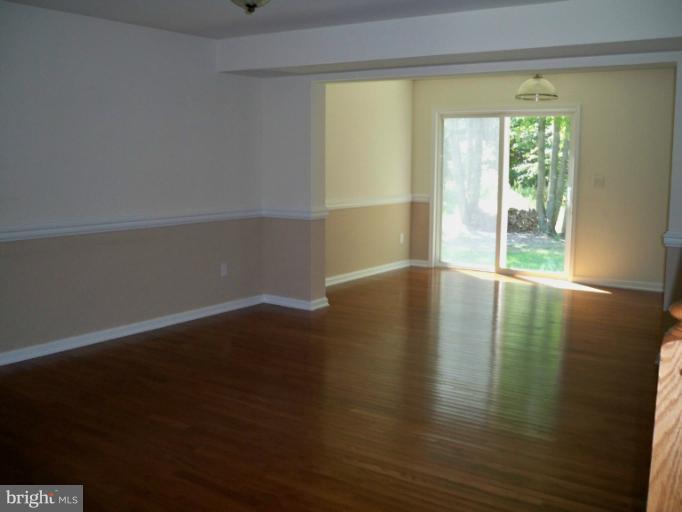 1458 Cox Neck Road Chester, MD 21619 - Photo 4 of 20 a view of an empty room with wooden floor and a window