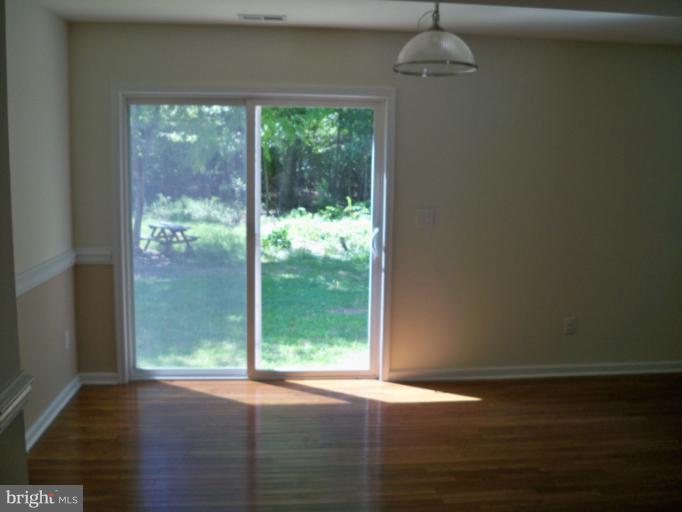 1458 Cox Neck Road Chester, MD 21619 - Photo 5 of 20 a view of a room with wooden floor and windows