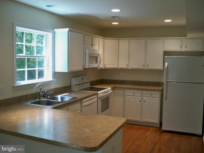 1458 Cox Neck Road Chester, MD 21619 - Photo 6 of 20 a kitchen with granite countertop a sink stainless steel appliances and cabinets