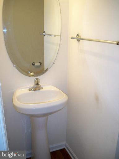 1458 Cox Neck Road Chester, MD 21619 - Photo 8 of 20 a bathroom with a sink a mirror and vanity