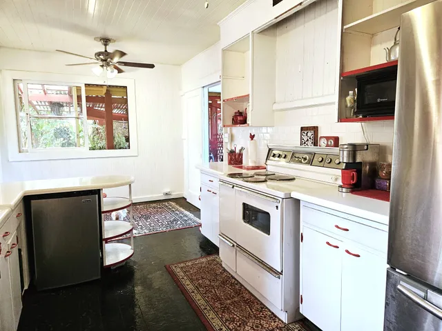 a kitchen with a stove a sink and a microwave