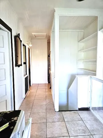 a view of a hallway to rooms and stairs