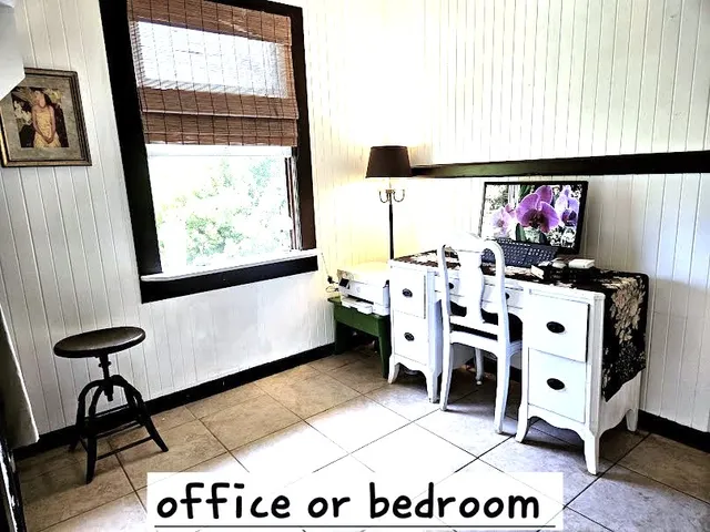 a living room with a large window and furniture