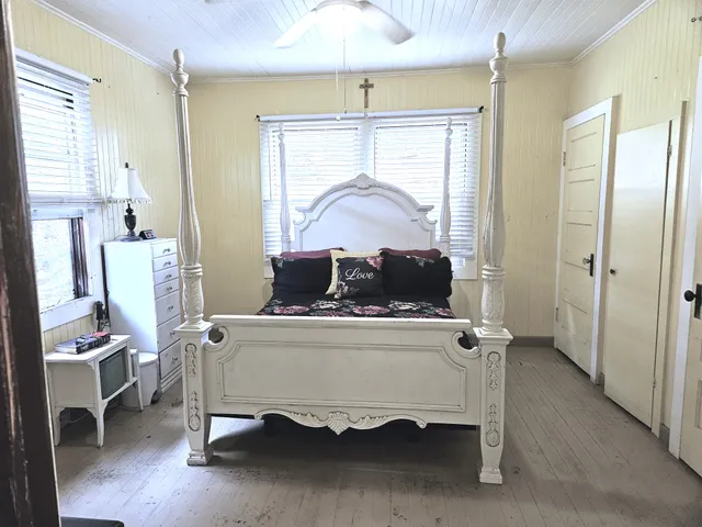 a bedroom with a bed and a chandelier