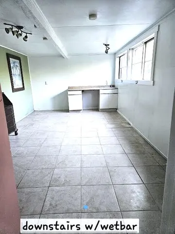 a view of a kitchen that has a sink and a stove in it