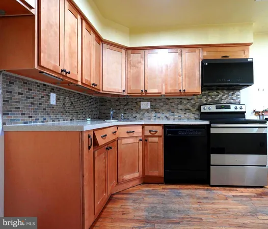 a kitchen with stainless steel appliances granite countertop a stove and a microwave