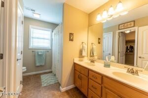 338 Pistole Road Sparta, TN 38583 - Photo 23 of 39 a bathroom with a double vanity sink and a mirror
