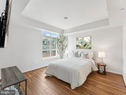 a bedroom with a bed and wooden floor