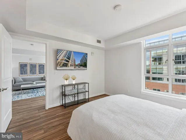 a bedroom with a bed and a large window