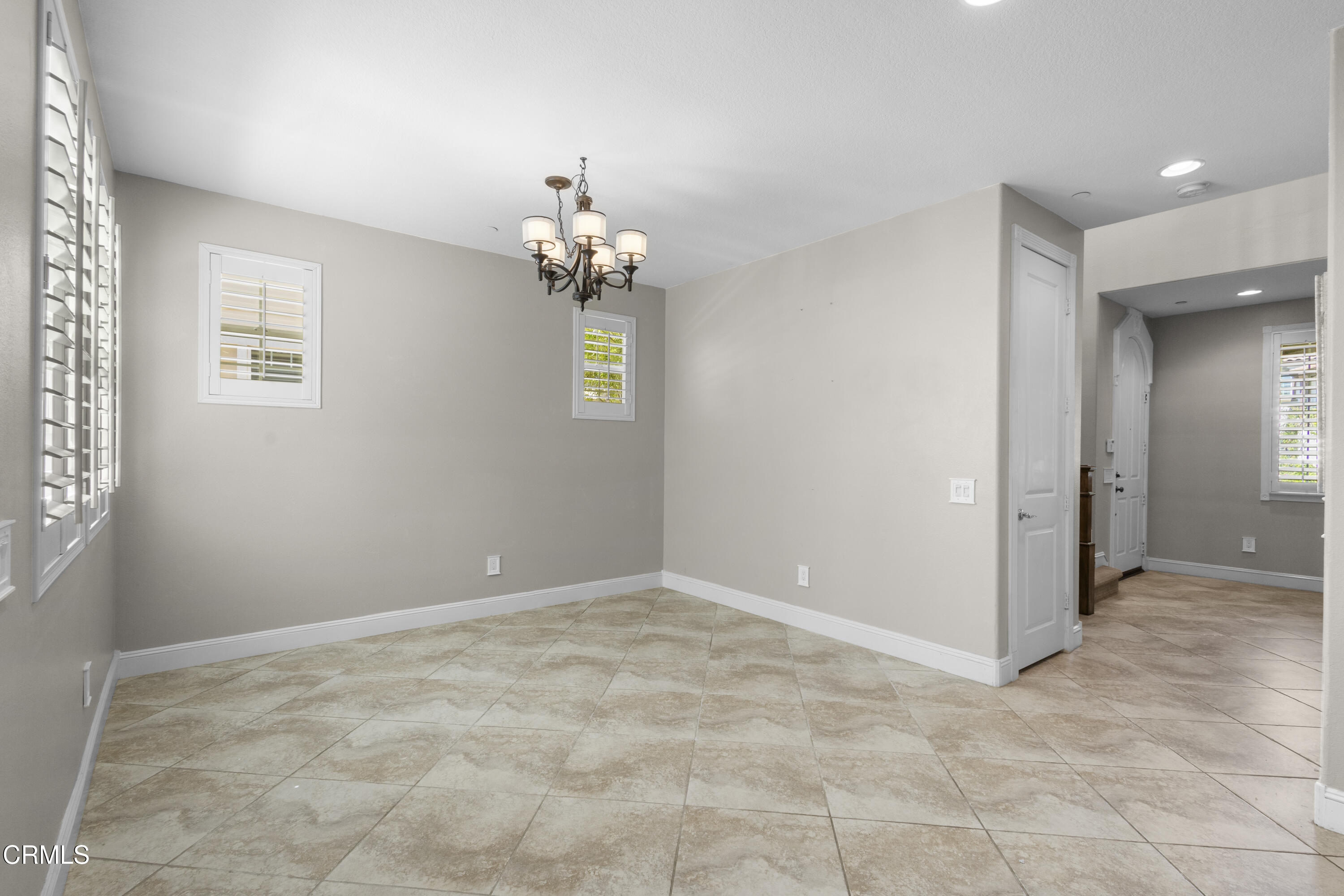1315 Donegal Way Oxnard, CA 93035 - Photo 13 of 48 an empty room with a chandelier fan and windows
