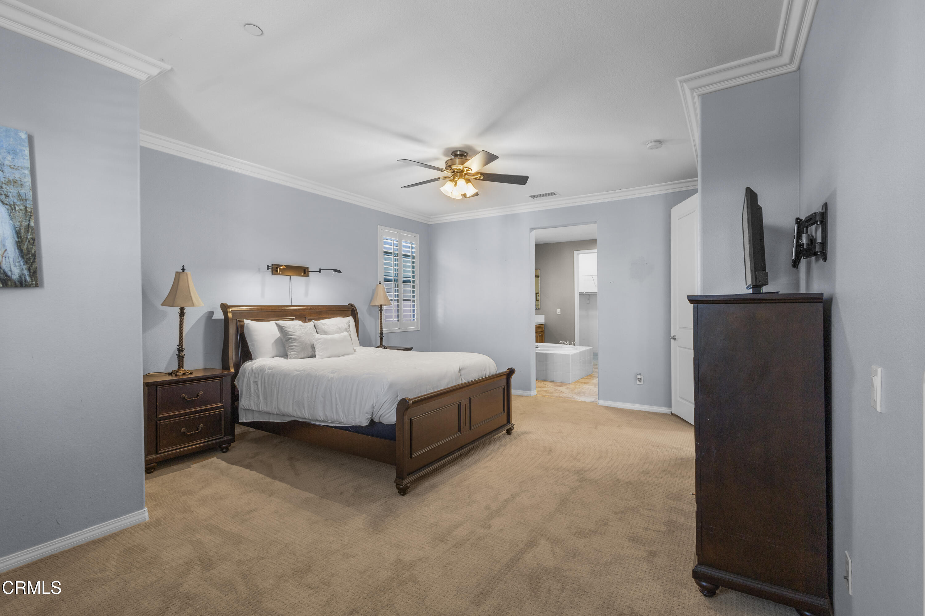 1315 Donegal Way Oxnard, CA 93035 - Photo 28 of 48 a bedroom with a bed and a chandelier