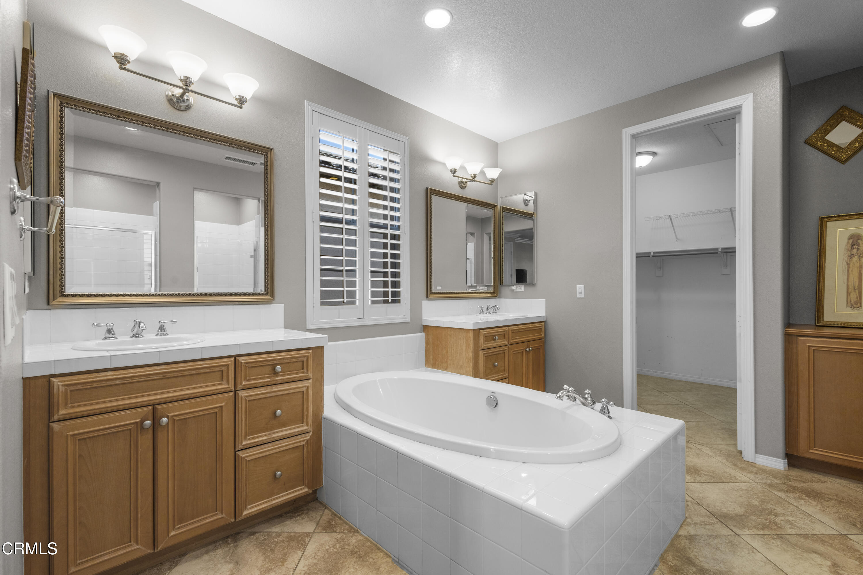1315 Donegal Way Oxnard, CA 93035 - Photo 30 of 48 a bathroom with a tub sink and mirror