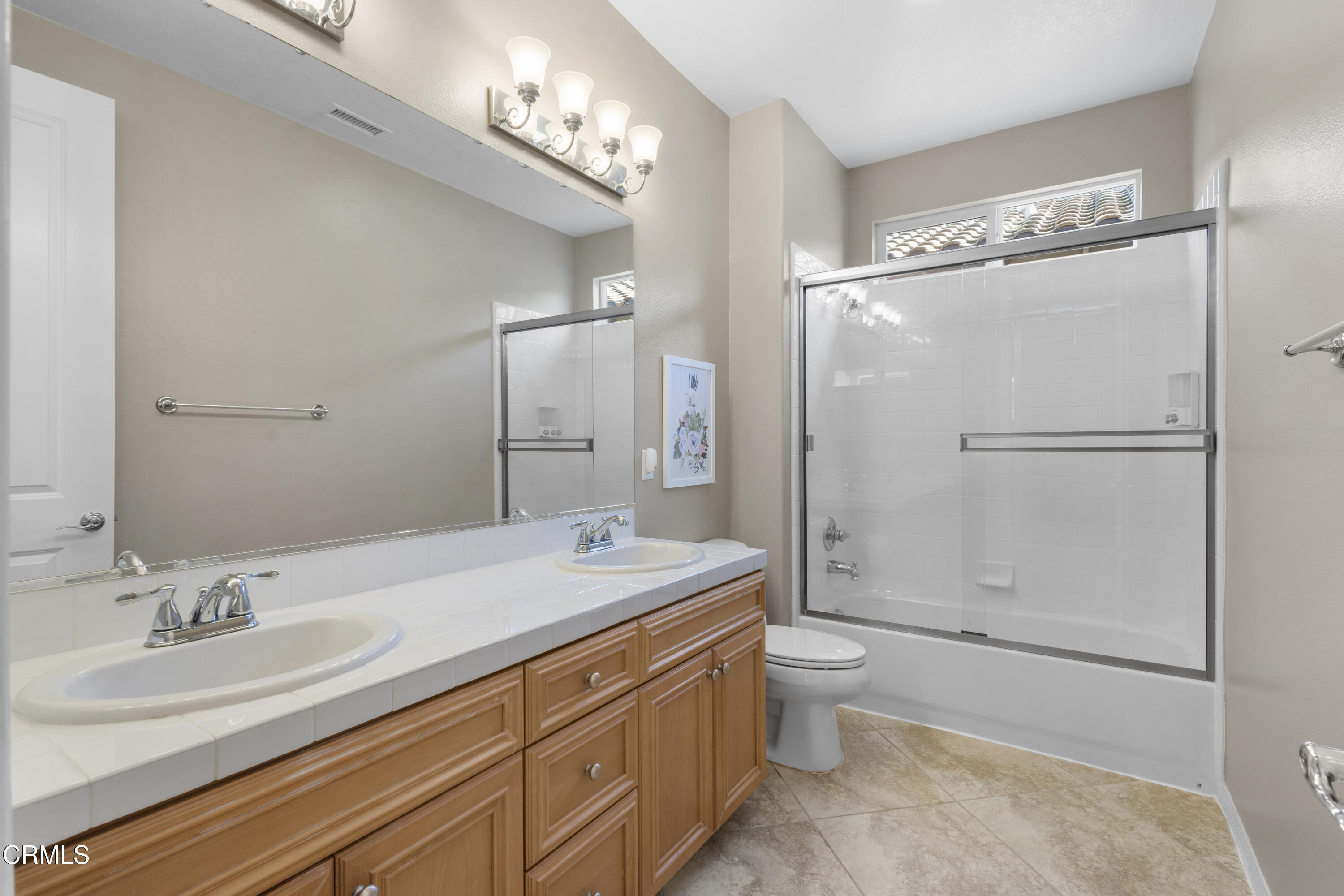 1315 Donegal Way Oxnard, CA 93035 - Photo 40 of 48 a bathroom with a double vanity sink toilet mirror and shower