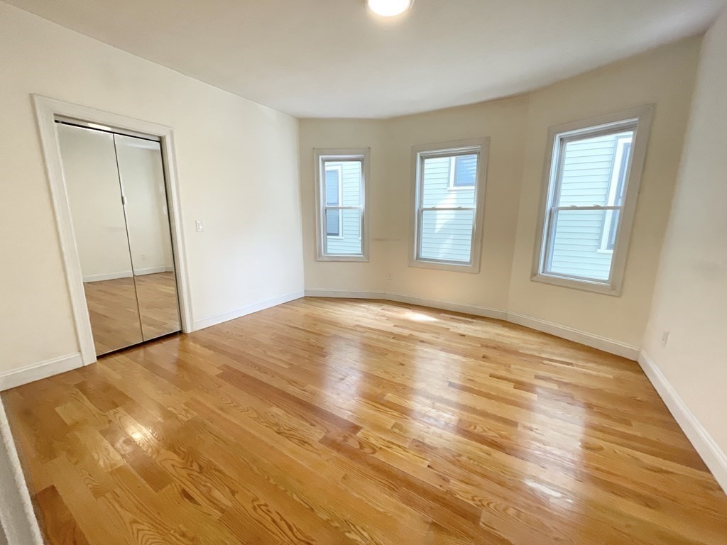 7 Sudan Street, Unit 2 Boston, MA 02125 - Photo 3 of 10 a view of empty room with wooden floor and fan