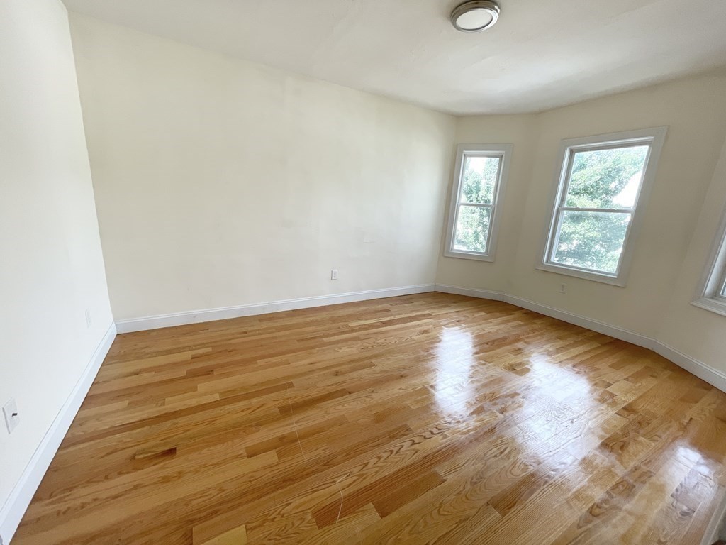 7 Sudan Street, Unit 2 Boston, MA 02125 - Photo 5 of 10 a view of empty room with wooden floor and fan