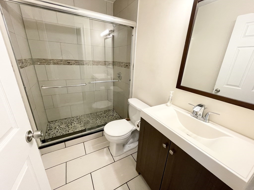 7 Sudan Street, Unit 2 Boston, MA 02125 - Photo 8 of 10 a bathroom with a sink a toilet and shower