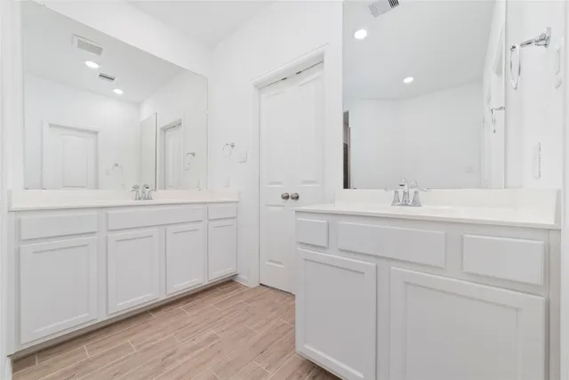 a bathroom with double vanity sink a mirror and vanity