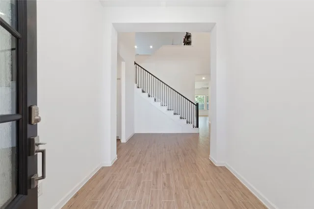 a view of a hallway with wooden floor
