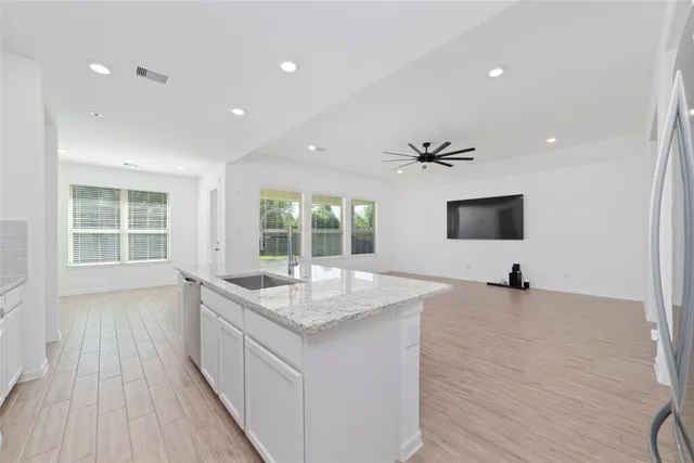 a kitchen with a sink and a large window