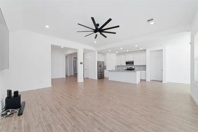 a view of a kitchen with a sink and dishwasher a refrigerator with wooden floor