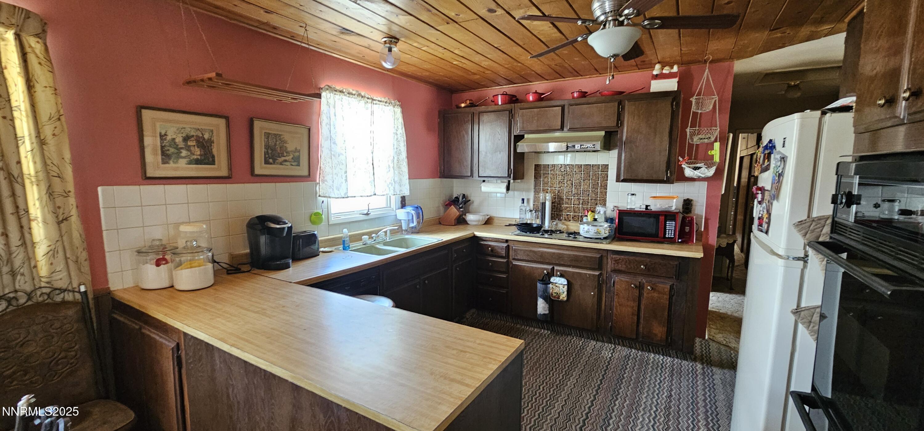 316 Toiyabe Road Kingston, NV 89310 - Photo 16 of 32 a kitchen with a sink stove and refrigerator