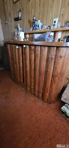 a bedroom with a bed and a flat tv screen on dresser
