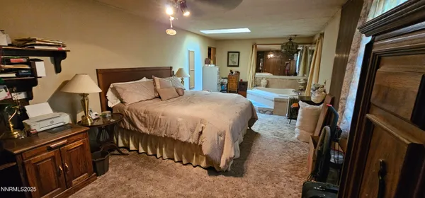 a very nice looking room with a large bed a flat tv screen and dresser