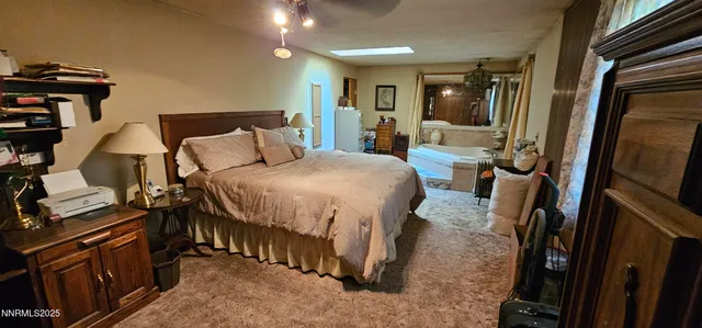 a very nice looking room with a large bed a flat tv screen and dresser