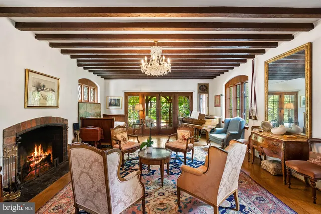 a living room with furniture fireplace and a large window