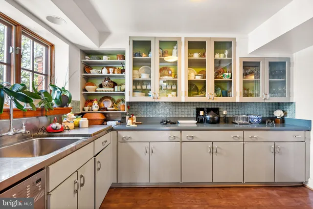 a kitchen with stainless steel appliances granite countertop a sink and cabinets