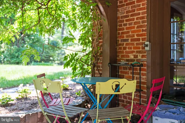 a view of a chairs and table in patio